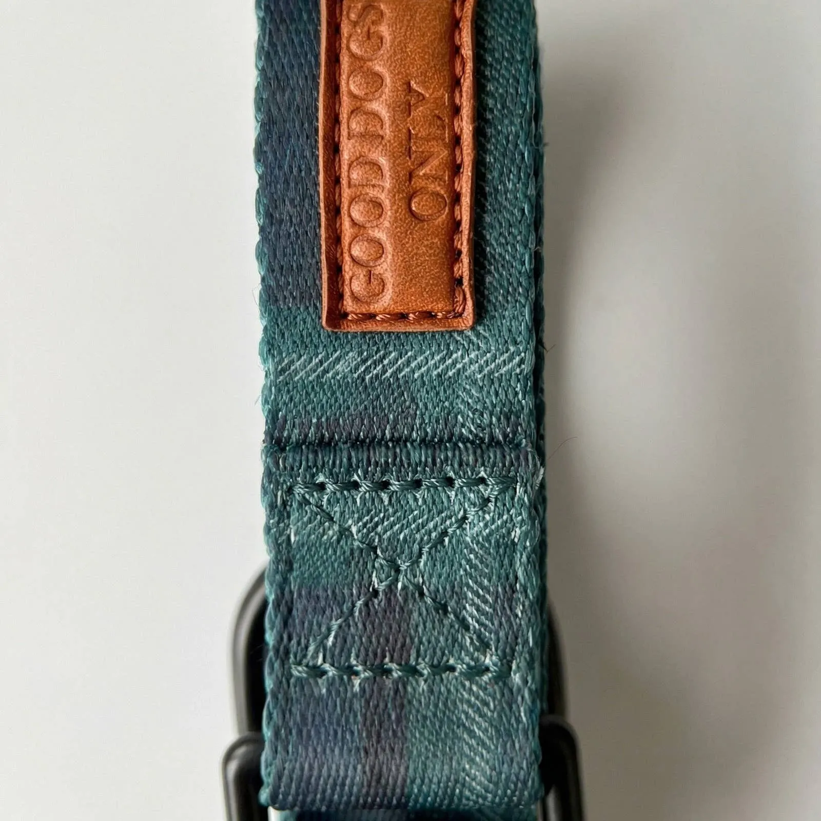 Close-up of the plaid and leather tab